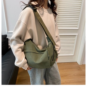 Detail of green corduroy hobo bag with adjustable strap and soft ribbed texture