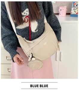 Detail of beige nylon crescent crossbody bag with a round detachable small coin purse