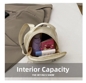 Internal capacity of nylon crossbody bag showing umbrella, wallet and phone storage