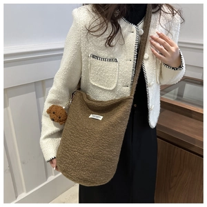 Brown fuzzy teddy bucket bag with crossbody strap and bear charm for winter fashion