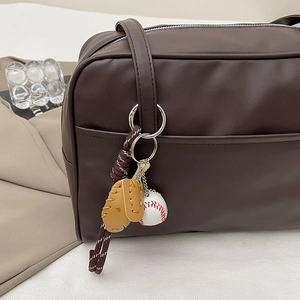 Retro dark brown leather tote bag with a unique baseball and glove charm decoration