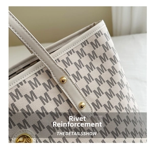 Macro detail of the reinforced rivet strap and beige leather monogram texture on tote bag
