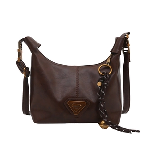 Retro dark brown hobo bag with vintage leather texture and metal triangle plaque