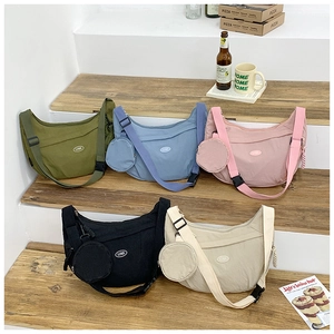 Detail view of five colors nylon crescent crossbody bags with small round coin pouches
