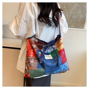 Detail of bohemian patchwork floral tote bag with Meetyou label and blue drawstring bow