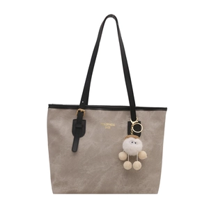 Minimalistische taupefarbene große Tote Bag mit schwarzen Lederriemen und Plüsch-Anhänger