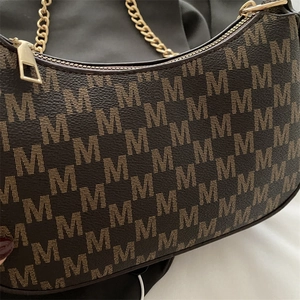 Vintage brown monogram shoulder bag with gold chain strap and elegant texture