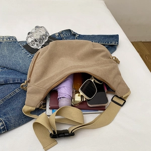 Large khaki corduroy crescent crossbody bag showing spacious interior with daily essentials
