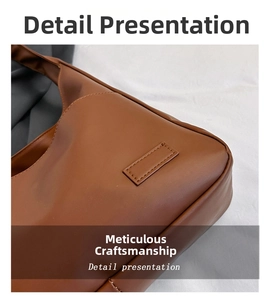 Detailed close-up of refined stitching and leather patch on brown tote bag