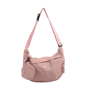 Pink nylon crescent crossbody bag with adjustable wide strap and small round coin purse