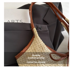 Close-up of straw woven tote with premium brown leather trim and detailed stitching