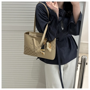 Close-up of khaki tote bag featuring checkered texture, contrast panels and silk scarf