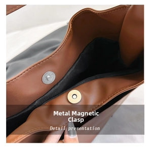 Detail of the high-quality magnetic closure on a brown vintage tote bag with fabric lining
