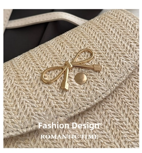 Detailed view of woven fabric texture and gold bow metal clasp on apricot crossbody bag