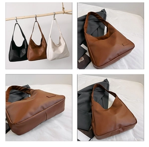 Three-color minimalist hobo tote bags displayed on wooden hangers and grey fabric background