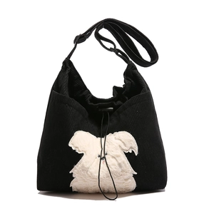 Fashionable black corduroy tote bag with cute plush puppy patch and drawstring strap