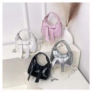Multiple views of sweet bow bucket bags in pink, white, silver, and black with chain