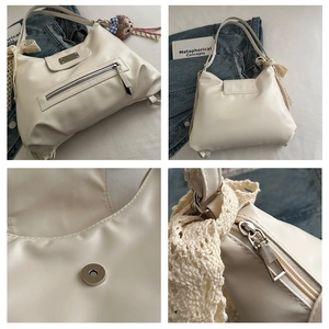 Detailansicht der cremefarbenen Kunstledertasche mit Magnetverschluss und Spitze-Anhänger
