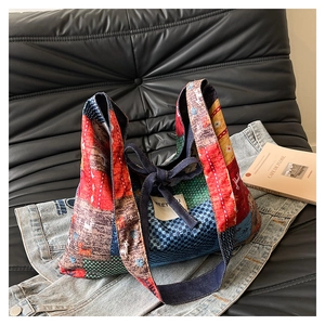 Detailed patchwork tote bag featuring floral patterns, denim bow, and woven MEET label