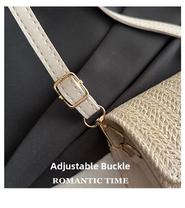 Detail view of the beige woven straw handbag featuring an adjustable gold metal buckle strap