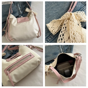 Detail view of pink and white tote bag with lace bow, rear zipper, and interior storage