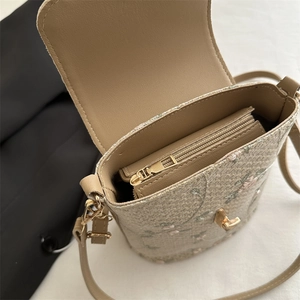 Straw bucket bag with pink floral embroidery and metallic zipper compartment