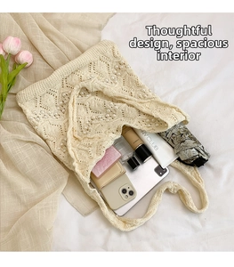 Detail of hollow knit tote bag with pearl accents showing spacious interior and items