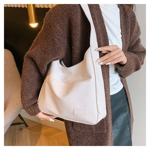 Detail showing the front pocket and cream white texture of the casual tote bag for women