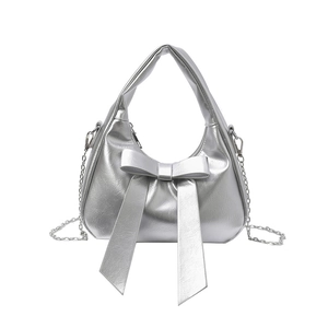 Silver metallic underarm bag with a large bow detail and detachable chain strap