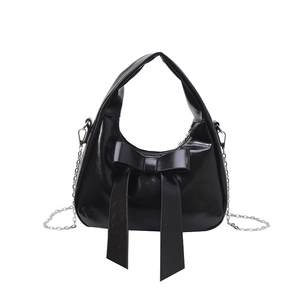 Chic black hobo bucket bag featuring a large bow and metallic chain detail