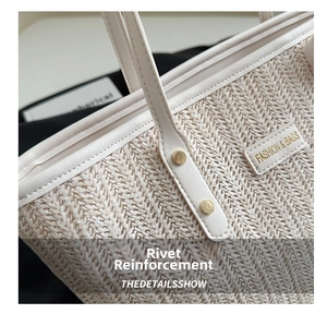 Detail of woven straw tote with reinforced gold rivets and fashion leather label