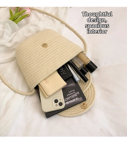 Top view of woven crossbody bucket bag interior showing capacity for phone and cosmetics