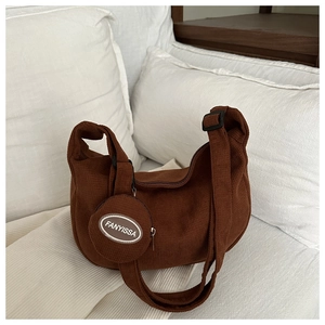 Detailed texture of brown corduroy hobo bag with a matching mini round coin purse
