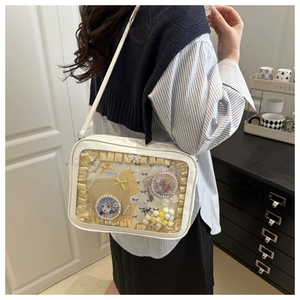 White ita bag with transparent window featuring yellow ruffles and anime badges decoration