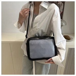 Detail of black crossbody ita bag with mesh window and adjustable shoulder strap