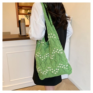 Green knitted hollow tote bag featuring wave pattern and white pearl decorations