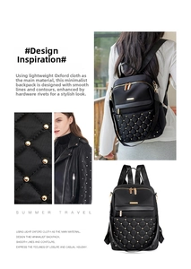 Detail of black oxford fabric backpack with quilted pattern and gold metal rivets