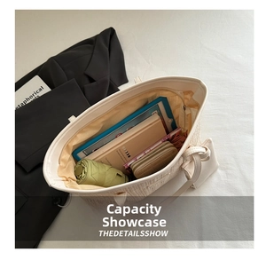 Detail view of large straw woven tote bag showing spacious interior with daily essentials