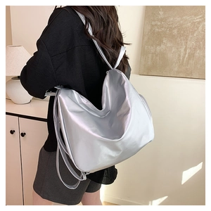 Detailed view of a metallic silver large tote bag made of glossy coated PU material