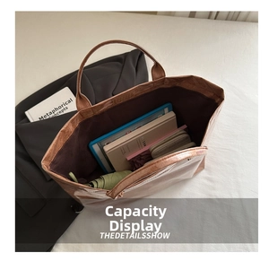 Spacious tote bag interior showing capacity for tablets and books with glossy texture