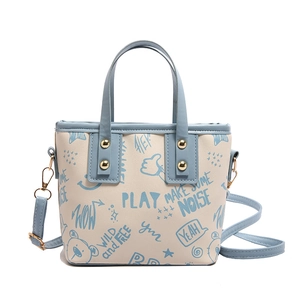 Minimalist large tote bag with light blue graffiti print and adjustable shoulder strap