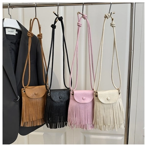 Detail view of boho tassel crossbody bags in four colors with faux leather finish