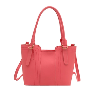 Minimalist coral pink women's bucket bag with vertical stitching and gold hardware details