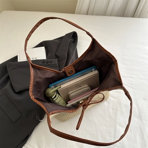 Straw woven tote bag with brown leather trim showing large capacity for essentials