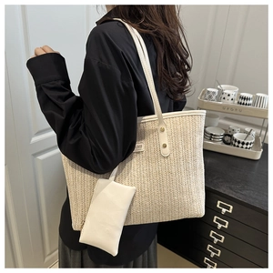 Detail of woven straw tote bag with PU leather straps and matching hanging coin purse