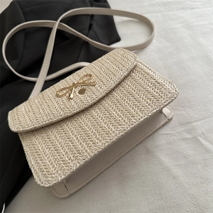 Chic beige straw woven crossbody bag with elegant golden bow metal clasp for women