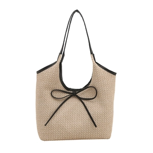 Straw tote bag with black bow and leather trim shown from a centered front perspective