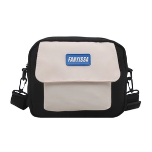 Minimalist black and white canvas crossbody bag with adjustable strap and logo detail