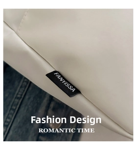 Close-up of FANYISSA brand tag on white water-resistant nylon shoulder bag for women