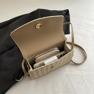 Fashionable beige straw crossbody bag with magnetic closure and slim shoulder strap